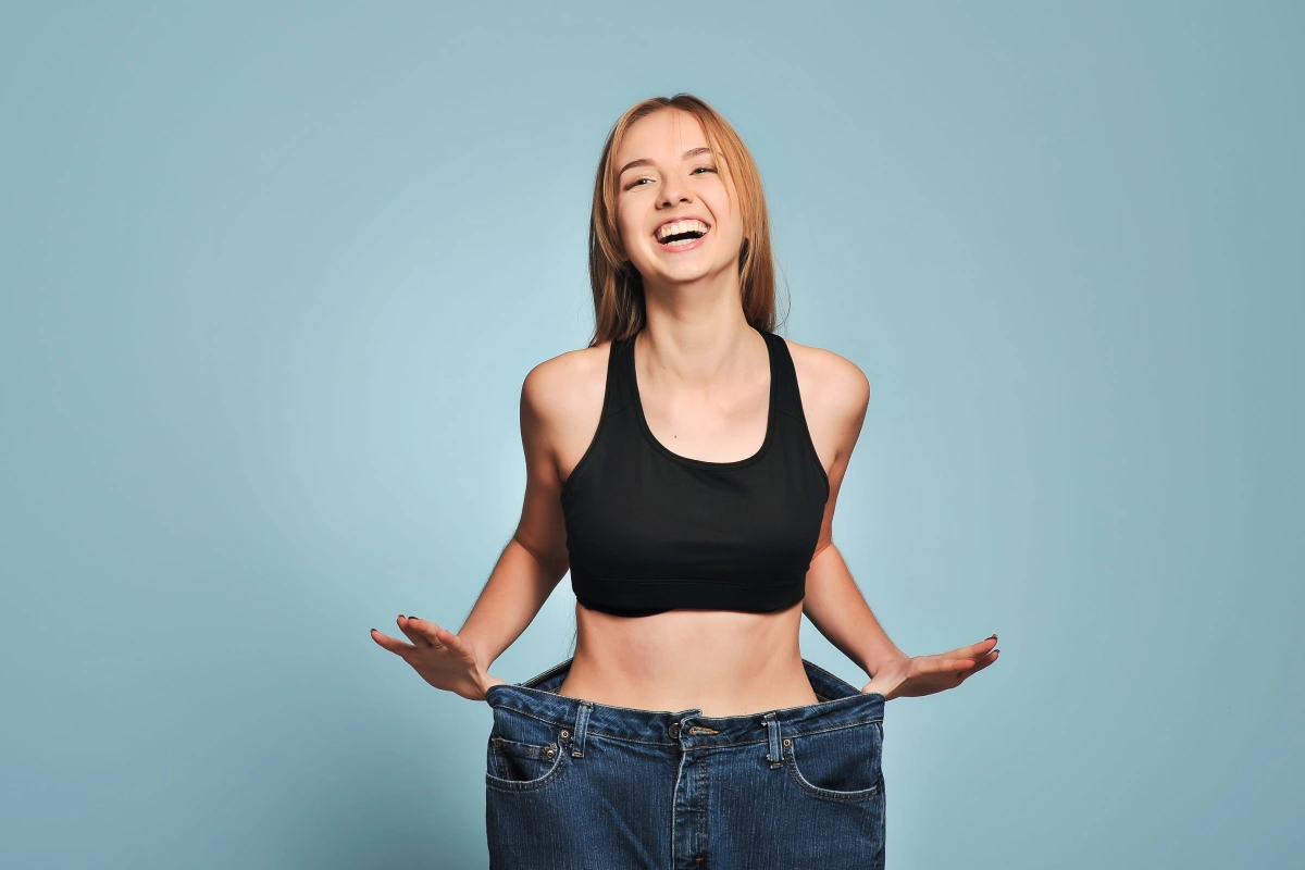 Happy woman showing weight loss results after Fat Loss Programs in Superior, CO